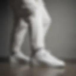 Elegant white sneakers paired with a tailored suit