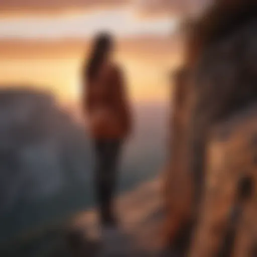 A person standing confidently at the edge of a cliff with a sunset background