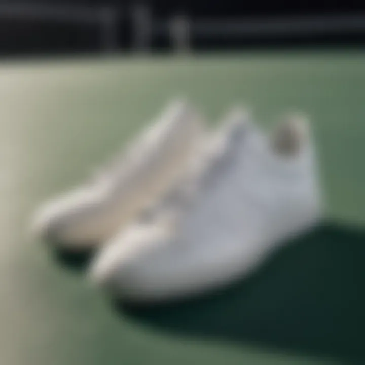 A stylish pair of white Adidas tennis shoes on a court