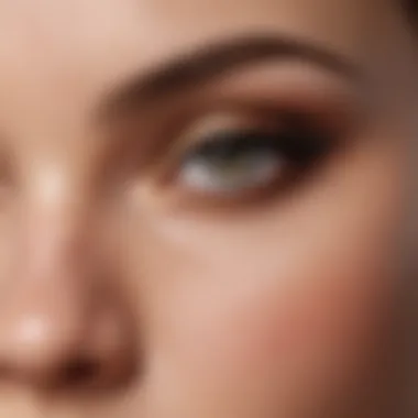 A close-up of a makeup brush applying eyeshadow, emphasizing the texture and blendability of the formula.