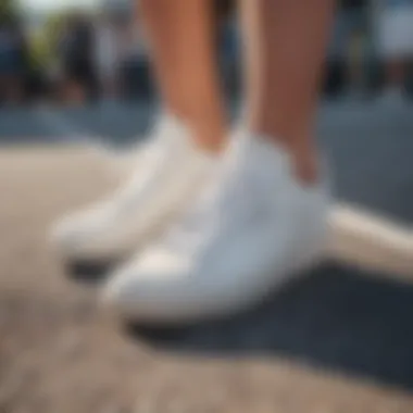 Thick white tennis shoes worn at a trendy outdoor event