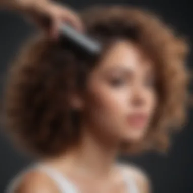 Close-up of a hand applying detangler to curly hair with a comb