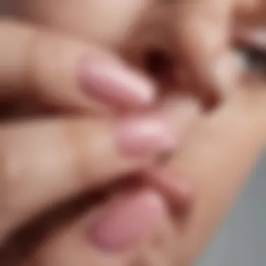 Close-up of a nail being painted with Essie Gel Couture